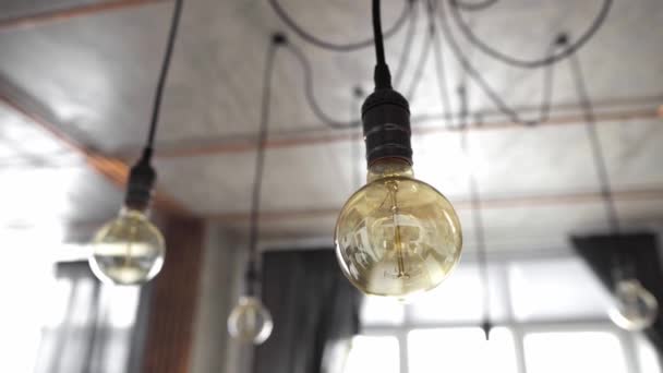 Dekorative antike Edison Glühbirnen mit geradem Draht. Große alte Glühbirnen hängen in der modernen Küche. Ineffiziente Glühbirnen verschwenden Strom. Dimmbar, Warmweiß, E27 - Filmmaterial, Video