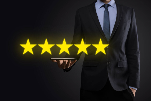 企業の評価を高めるために5つ星のシンボルを指しています。レビュー、評価やランキング、評価と分類の概念. - 写真・画像