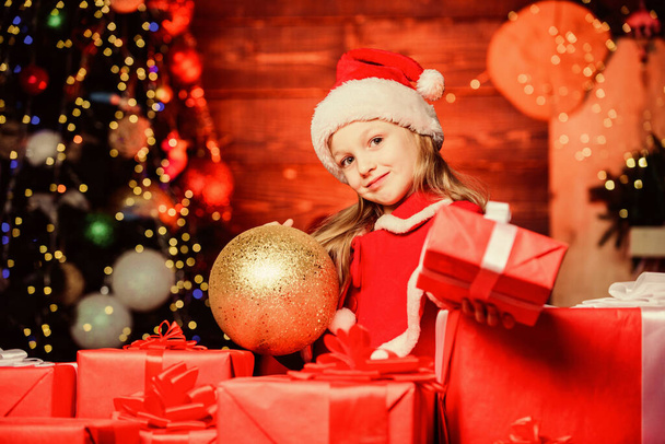 Christmas gift for you. Happy little girl giving new year gift. Small child holding gift box on boxing day. Adorable kid with beautifully wrapped Christmas gift. Wrapping it up very nicely - Foto, Imagem