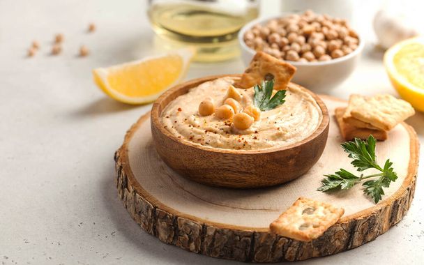 hummus in a wooden plate, chickpeas, croutons. Dishes of chickpeas, a vegetarian dish. Copy space. - Photo, Image
