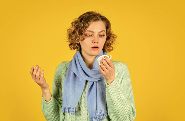 sick woman sneezing at home. Holding Handkerchief to her Runny Nose. concept of treating allergies or colds. runny nose. woman with allergy blowing her nose. Coronavirus outbreak concept - 写真・画像
