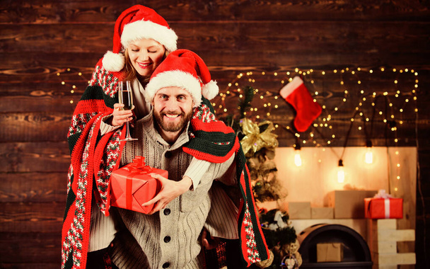 Man and woman santa claus hats cheerful celebrating new year. Merry christmas. Guy piggybacking girl. Celebrating together. Celebrating winter holiday. Christmas fun. Interesting ideas celebration - Φωτογραφία, εικόνα