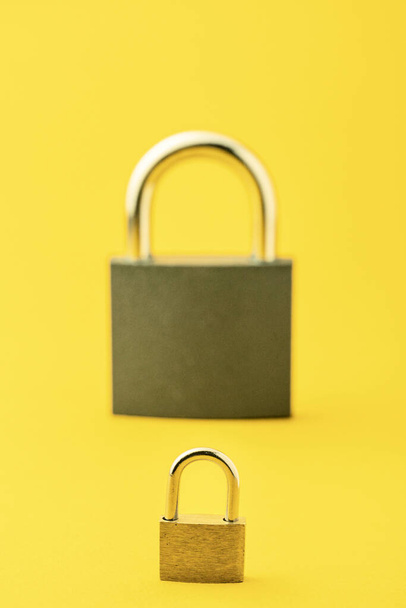 2 locks on a yellow background. - Fotografie, Obrázek