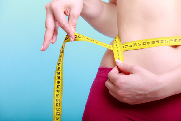 Diet. Fitness woman fit girl with measure tape measuring her waist - Fotoğraf, Görsel