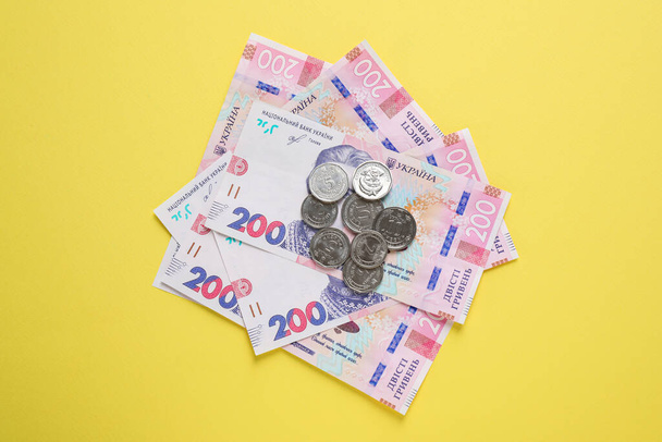 Ukrainian money on yellow background, flat lay - Photo, Image