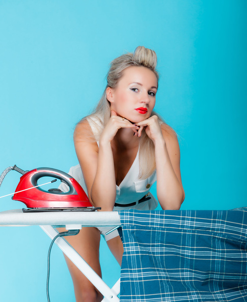 Sexy girl retro style ironing male shirt, woman housewife in domestic role. - 写真・画像