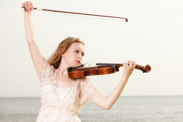 The blonde girl with a violin outdoor - Foto, Bild