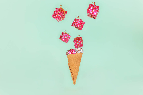 Ice Cream Cone with gift boxes. Minimal Holiday sale present concept. Flat Lay - Foto, Imagen