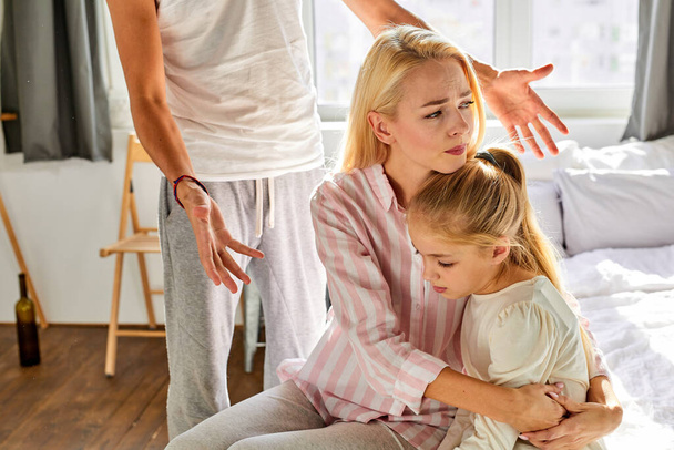 female parent with girl endure fathers disgusting behavior in the house - Valokuva, kuva
