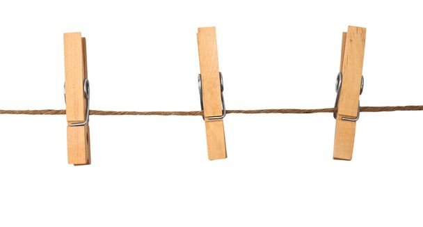 three clothespins on rope - 写真・画像