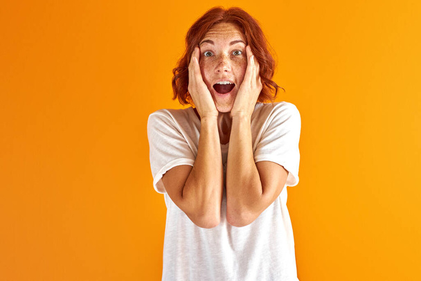 excited female with red hair scream after news - Fotografie, Obrázek