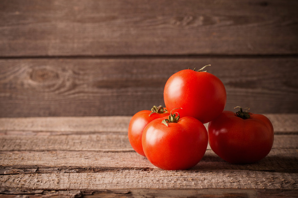 Tomatoes on a wooden surface - Fotografie, Obrázek