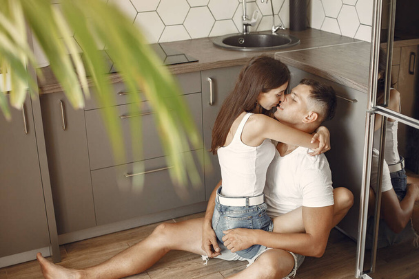 Beautiful couple spend time in a kitchen - Photo, image