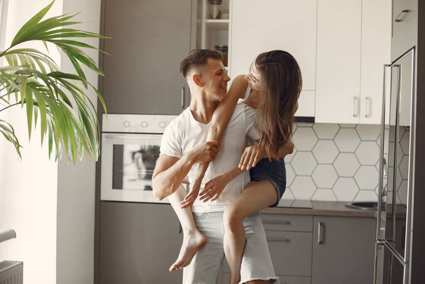 Beautiful couple spend time in a kitchen - Photo, Image