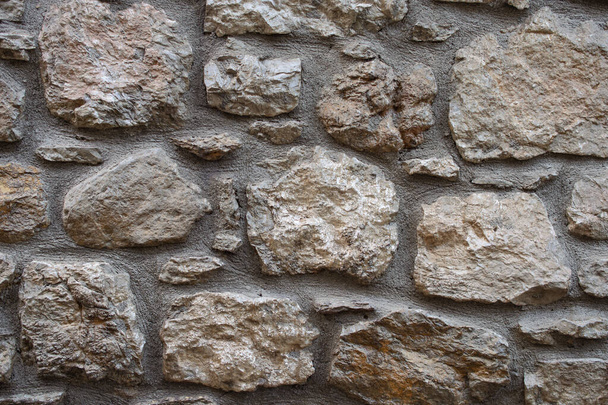 texture of the stone masonry. wall of large rough stones. Gray stone wall background. closeup - Foto, Imagem