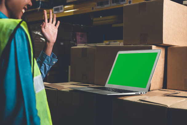 Computer with green screen display in warehouse storage room - 写真・画像