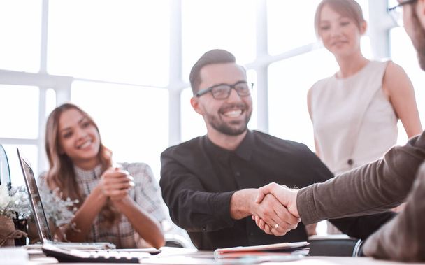 background image of the handshake of business partners in the office - Valokuva, kuva