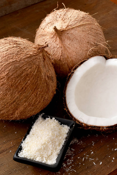 half of coconuts on a wooden background - Photo, Image