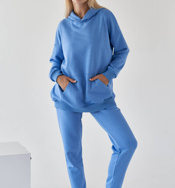 woman wears azure blue textile sport outfit - Photo, image
