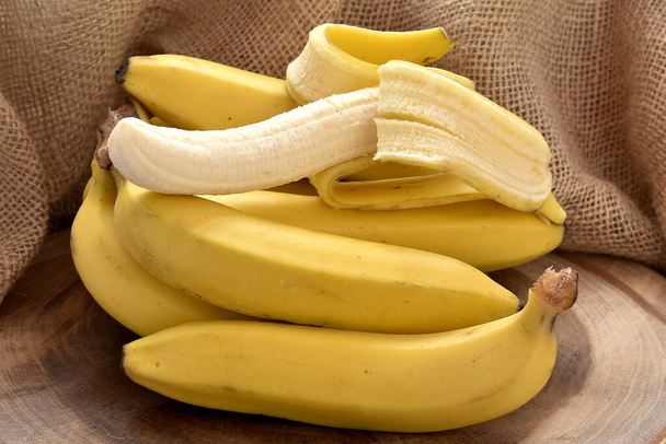 bunch of fresh bananas on a wooden background - Photo, Image