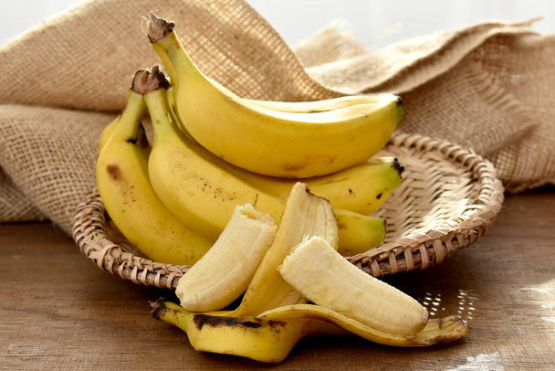 bunch of bananas on a wooden table - Photo, Image