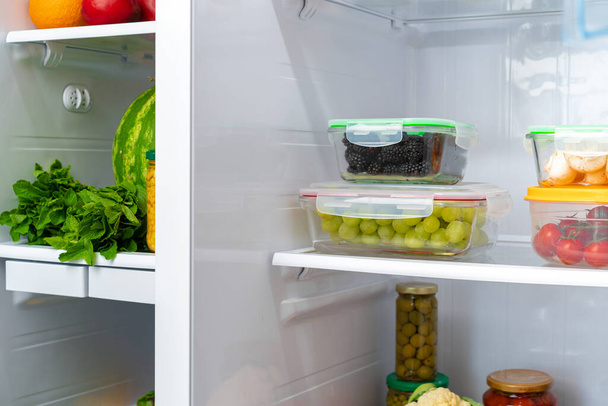Storage containers with fresh food in a fridge - 写真・画像