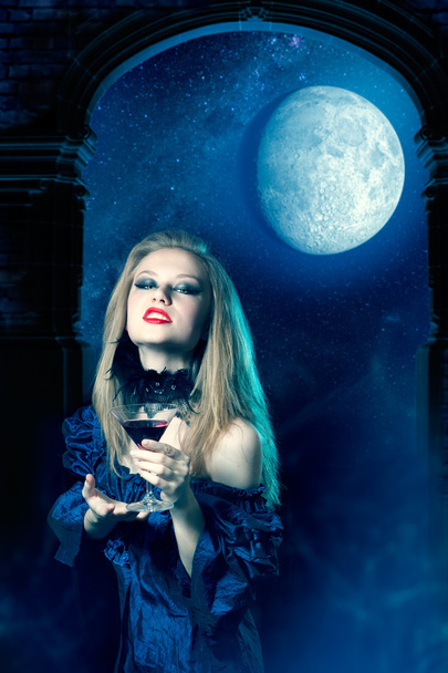 Vampire girl with glass of wine - Foto, imagen