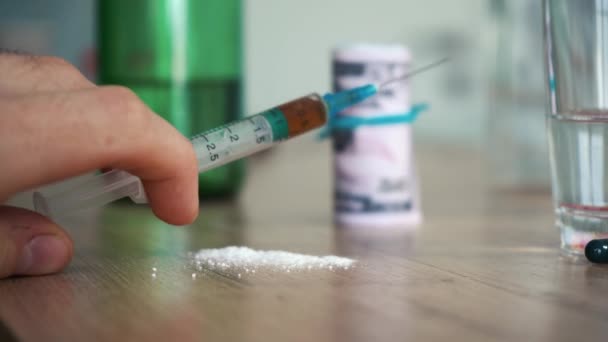 een man met een spuit met heroïne in zijn hand - Video