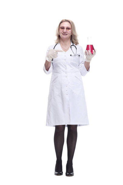 medical woman looking at the liquid in a laboratory flask. - Фото, зображення