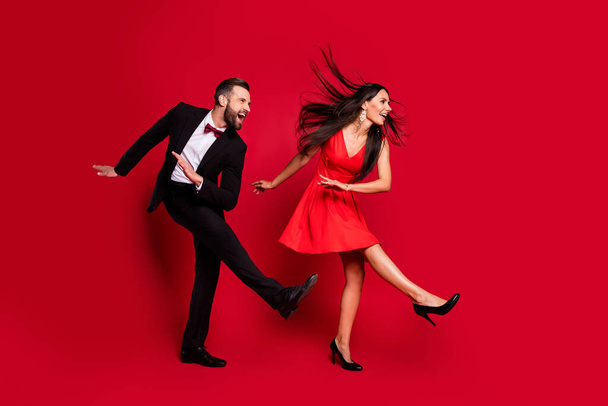 Full size profile photo of funny couple dance wear vivid dress black suit isolated on red color background - Fotografie, Obrázek