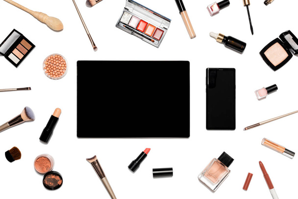 Decorative cosmetics and makeup tools on white background with tablet - Photo, Image