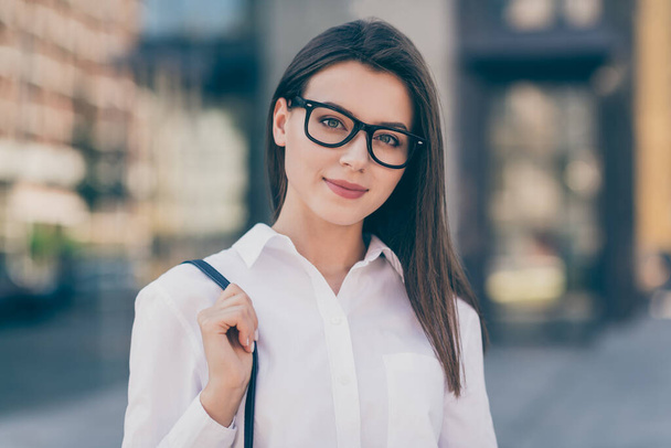 Photo of sweet pretty young lady dressed white formal shirt glasses hand arm handbag outside - Fotoğraf, Görsel