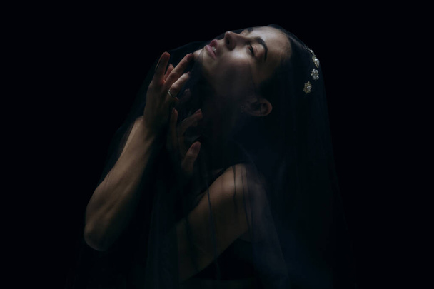 Graceful classic female ballet dancer isolated on black studio background. The grace, artist, movement, action and motion concept. - Фото, изображение