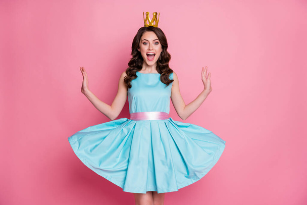 Photo of funny shocked fancy flirty playful lady prom event party recognized as prom queen golden crown on head throw skirt air fly wear blue teal dress isolated pink color background - Photo, image