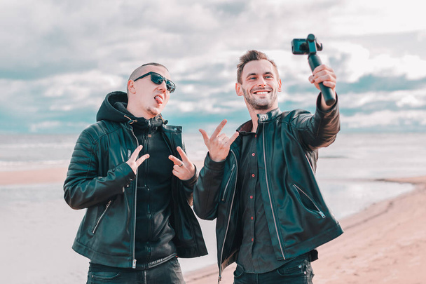 Two Handsome Guys Making Selfie Using Action Camera - Foto, imagen