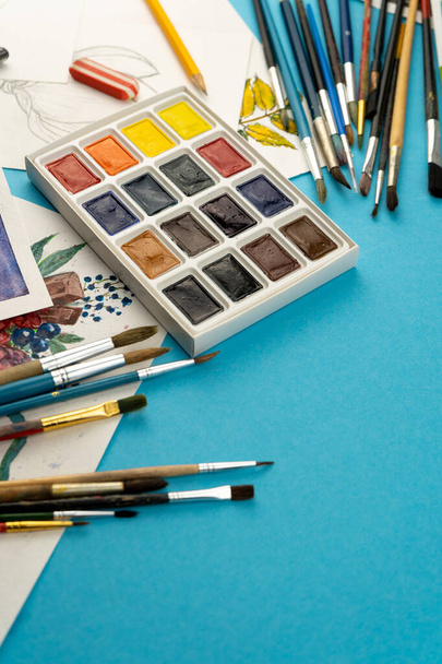 Watercolor paints and brushes. Artist's workplace and desk. Color palette. Drawing background. Place for your text. - Photo, image