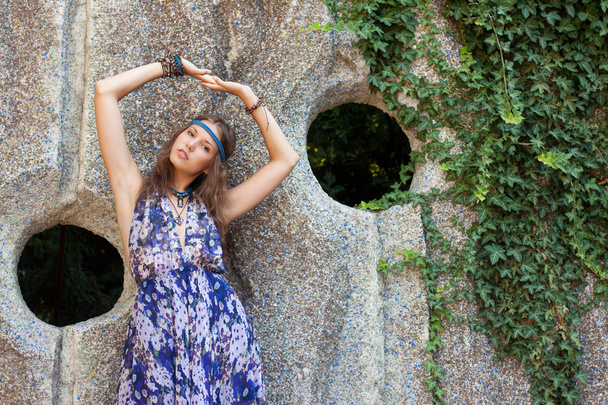 Woman in a sundress at the stone wall - 写真・画像