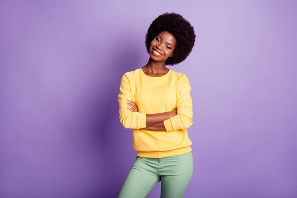 Photo of charming dark skin girl cross hands wear green trousers isolated over purple color background - Valokuva, kuva