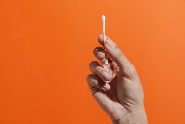 Close up of woman's hand holding a cotton swab isolated - Photo, image