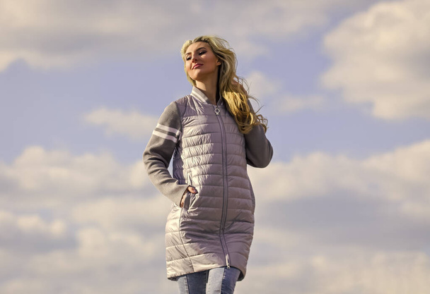 Windy day. Woman enjoying cool weather. Freshness of wind. Matching style and class with luxury and comfort. Beauty and fashion look. Girl jacket cloudy sky background. Woman fashion model outdoors - Valokuva, kuva
