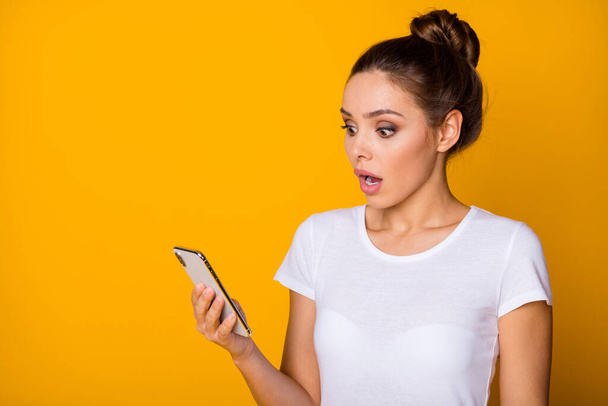 Omg its unbelievable. Astonished crazy girl use smartphone read incredible social network information comments impressed scream wear good look outfit isolated over bright color background - Foto, Imagen