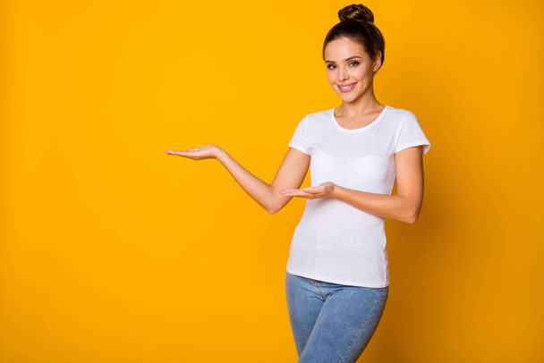 Portrait of positive cheerful girl promoter hold hand demonstrate adverts promotion wear good look clothes isolated over shine color background - Foto, Imagem