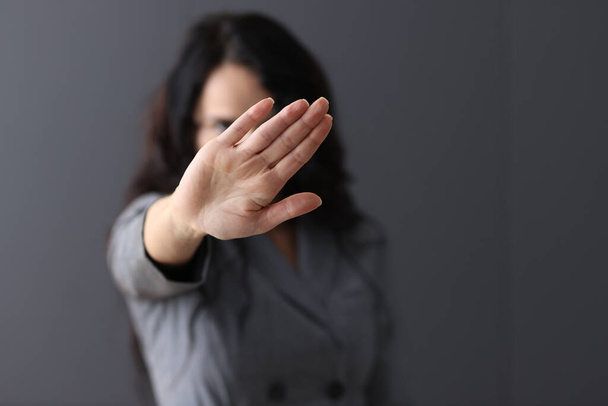 Woman shows negative gesture with her hand. - Photo, Image