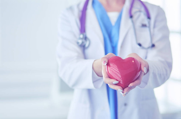 Doctor with stethoscope holding heart, isolated on white background - Photo, image