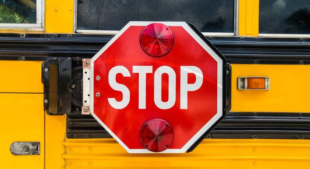 Stop sign on the back of school bus. - Фото, изображение