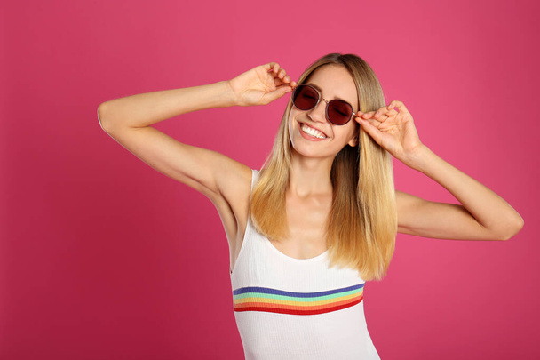 Beautiful woman in stylish sunglasses on pink background - Zdjęcie, obraz