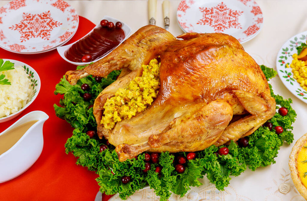 Christmas table served with turkey, decorated with kale and cranberry. Holiday New Year concept. - 写真・画像
