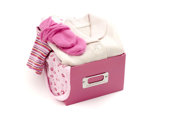 Close up of a box full with baby pink clean clothes isolated - Foto, immagini
