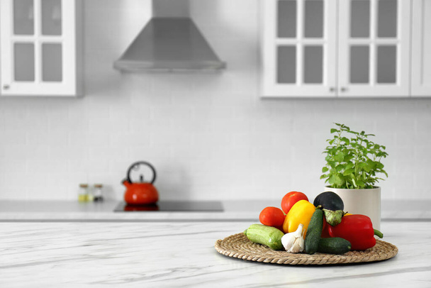 Different fresh vegetables on white table in modern kitchen. Space for text - Фото, зображення