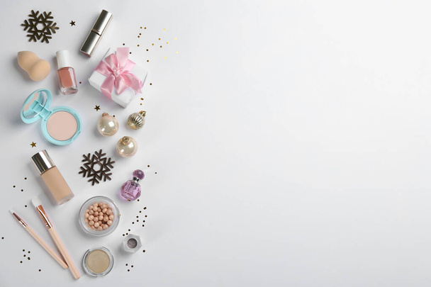 Flat lay composition with decorative cosmetic products on light background. Winter care. Space for text - Photo, Image